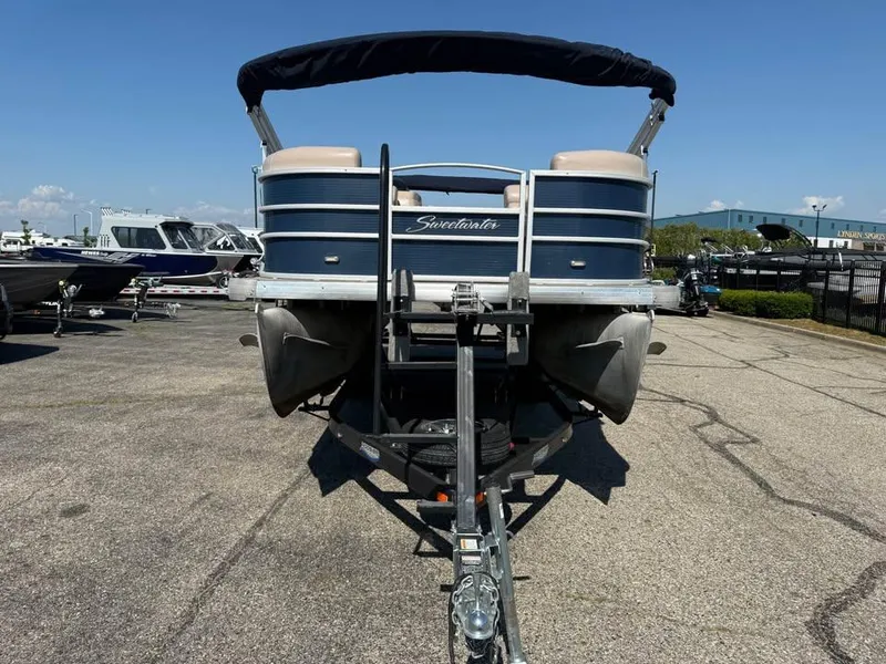 Slide: The Image of 2014 Godfrey 220 SL pontoon boat on trailer in marina parking lot. - 4