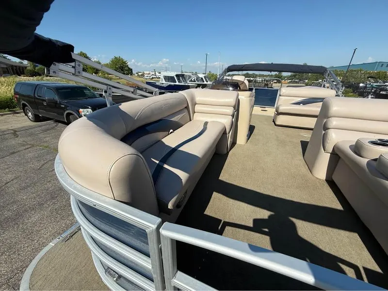 Slide: The Image of 2014 Godfrey 220 SL pontoon boat with beige seating and open deck layout. - 6