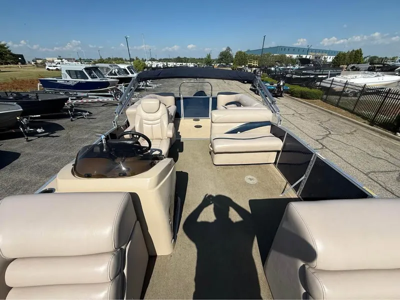 Slide: The Image of 2014 Godfrey 220 SL pontoon boat with beige seating, parked in a marina. - 8
