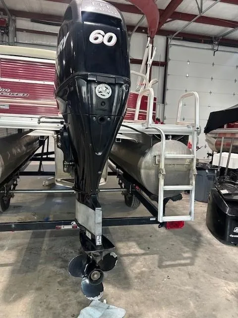 Slide: The Image of 2012 Sun Tracker Party Barge 20 DLX with Mercury 60 outboard motor in a garage. - 10