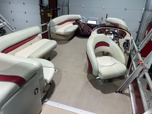 Slide: The Image of 2012 Sun Tracker Party Barge 20 DLX interior with plush seating and steering console. - 11