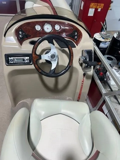 Slide: The Image of 2012 Sun Tracker Party Barge 20 DLX steering console with gauges and controls. - 14