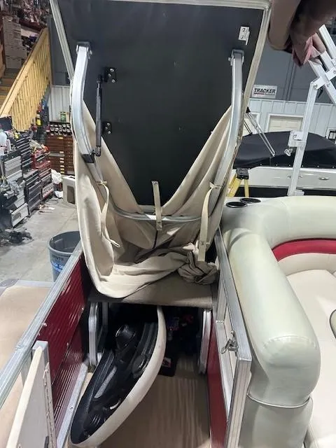 Slide: The Image of 2012 Sun Tracker Party Barge 20 DLX interior with open storage compartment. - 15