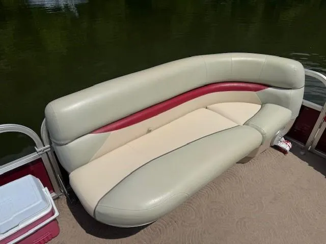 Slide: The Image of 2012 Sun Tracker Party Barge 20 DLX pontoon boat seating with beige and red upholstery. - 3