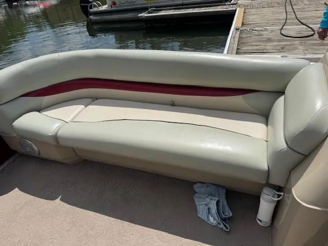 Slide: The Image of 2012 Sun Tracker Party Barge 20 DLX pontoon boat with beige seating and red accents. - 4