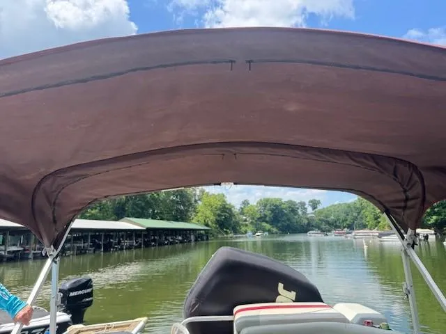Slide: The Image of 2012 Sun Tracker Party Barge 20 DLX on a serene lake under a blue sky. - 6