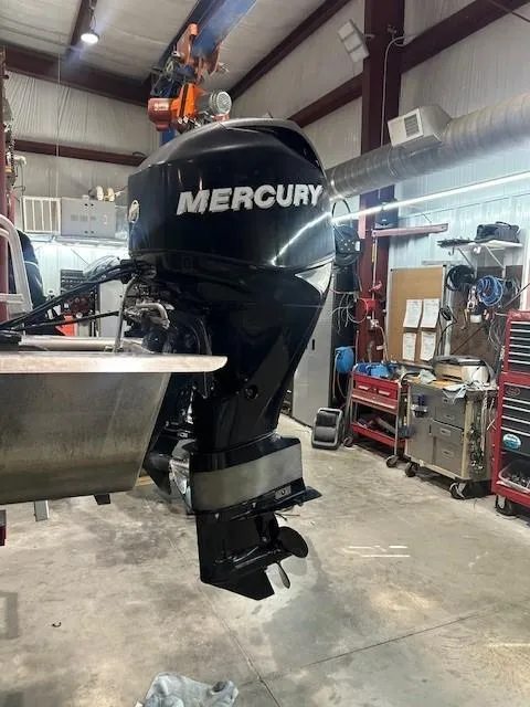 Slide: The Image of Mercury outboard motor on 2012 Sun Tracker Party Barge 20 DLX in a workshop setting. - 9