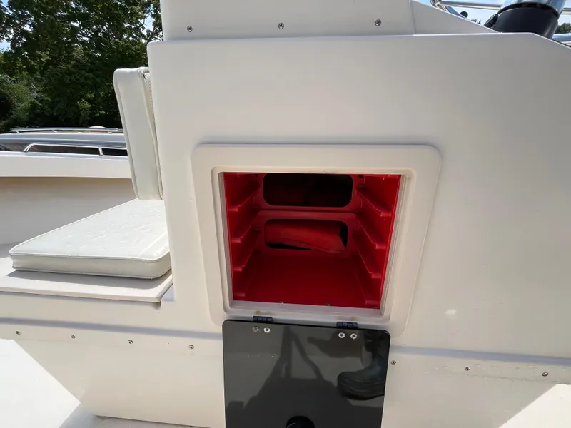 Slide: The Image of Open storage compartment on 2005 Parker 2100 Special Edition boat, featuring red interior shelves. - 12