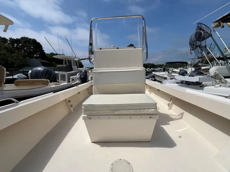 Slide: The Image of 2005 Parker 2100 Special Edition boat interior with seating, docked under clear skies. - 14