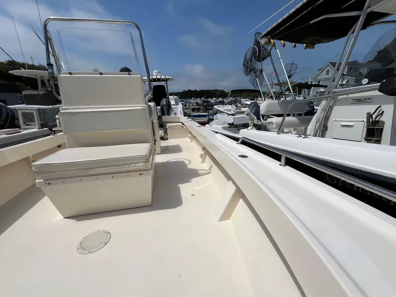 Slide: The Image of 2005 Parker 2100 Special Edition boat interior with seating, docked in a marina. - 15