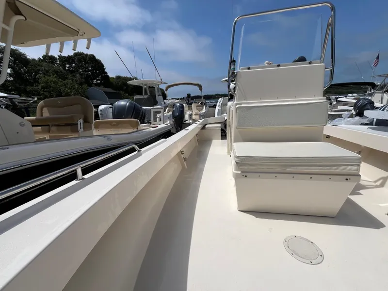 Slide: The Image of 2005 Parker 2100 Special Edition boat interior with seating and console, docked under clear skies. - 16