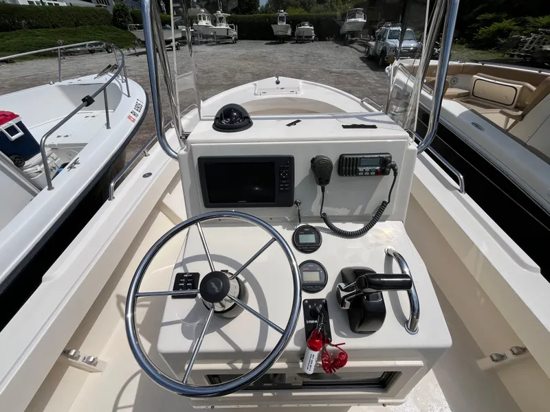 Slide: The Image of 2005 Parker 2100 Special Edition boat dashboard with steering wheel and navigation controls. - 19