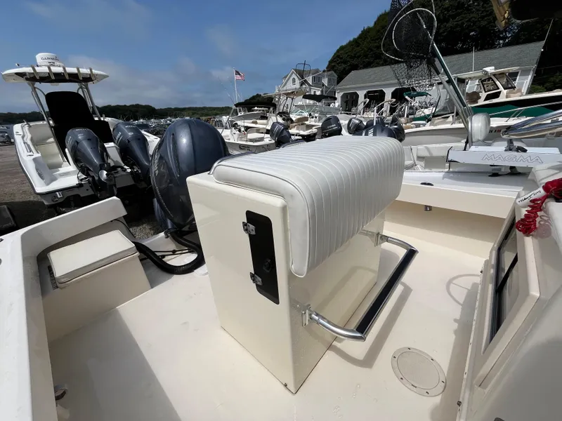 Slide: The Image of 2005 Parker 2100 Special Edition boat interior with seating and equipment at a marina. - 21