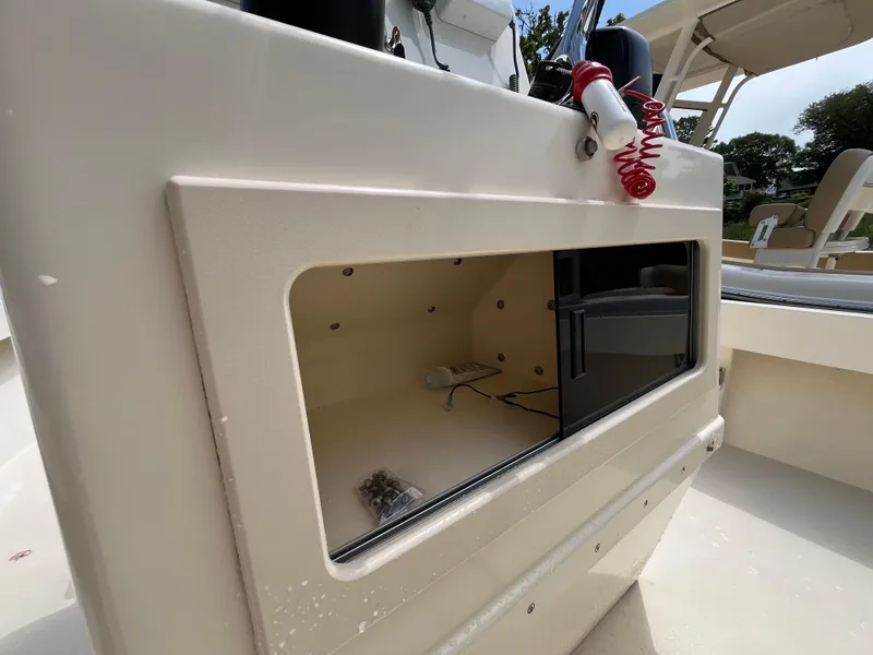 Slide: The Image of 2005 Parker 2100 Special Edition boat console with storage compartment and coiled red cord. - 25