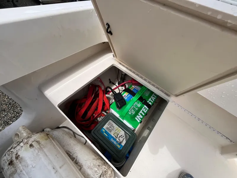 Slide: The Image of Storage compartment in a 2005 Parker 2100 Special Edition boat with battery and equipment. - 30