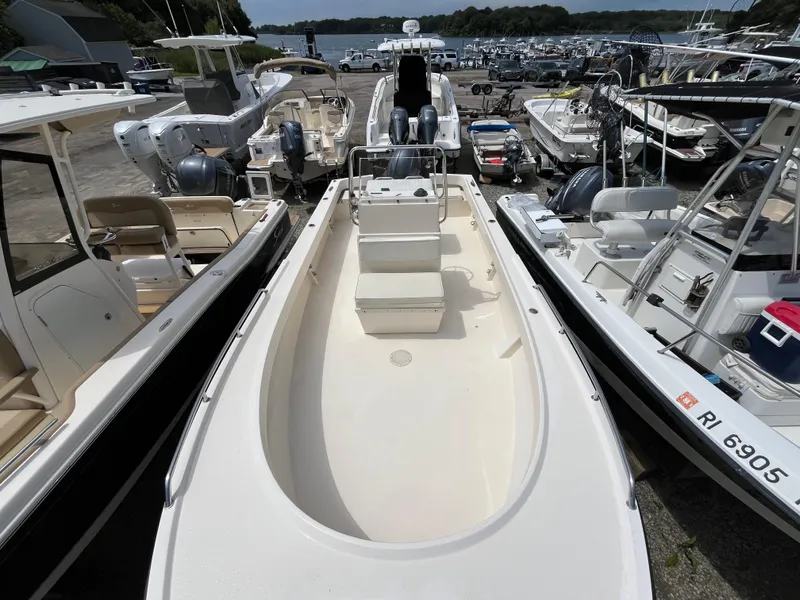 Slide: The Image of 2005 Parker 2100 Special Edition boat docked among other vessels at a marina. - 32