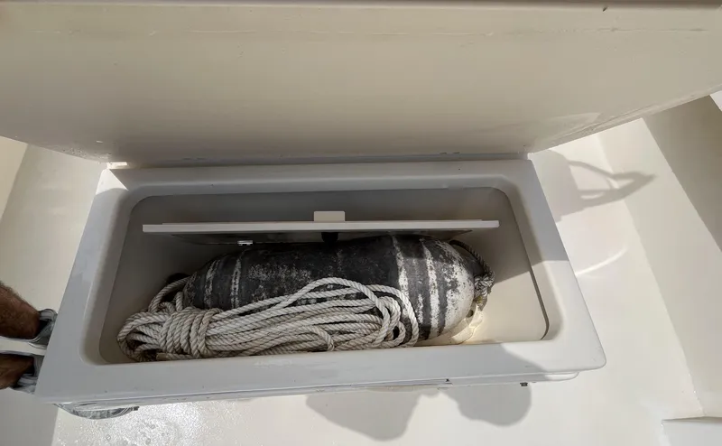 Slide: The Image of Open storage compartment on 2005 Parker 2100 Special Edition boat with rope and fender. - 33