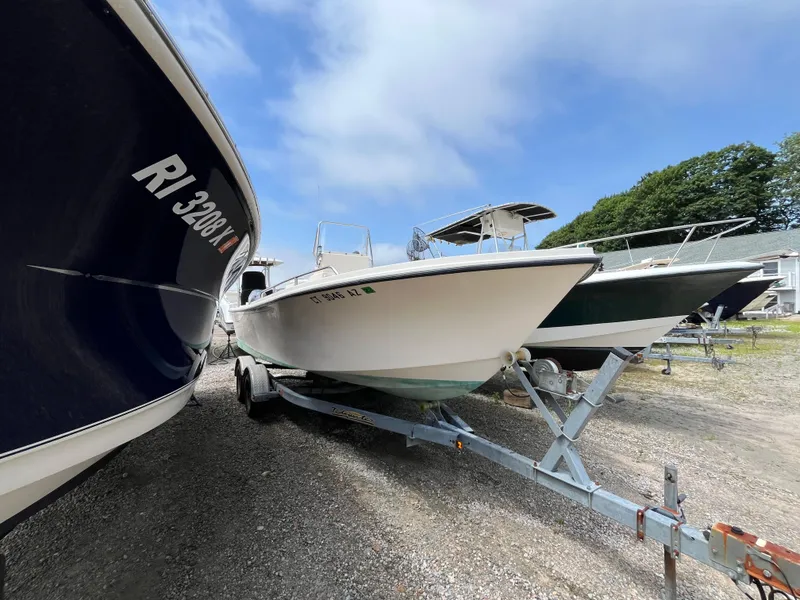 Slide: The Image of 2005 Parker 2100 Special Edition boat on trailer, surrounded by other boats, under a blue sky. - 37