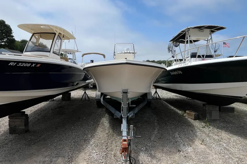 Slide: The Image of Three boats on trailers, including a 2005 Parker 2100 Special Edition, parked on gravel. - 38