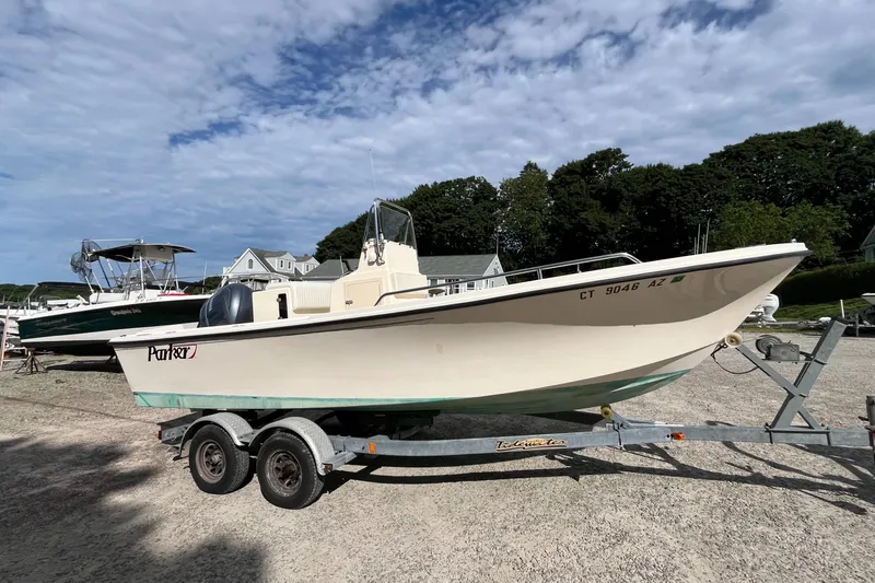 Slide: The Image of 2005 Parker 2100 Special Edition boat on trailer, parked outdoors under a cloudy sky. - 42