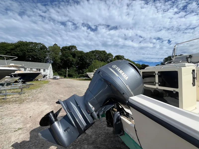 Slide: The Image of 2005 Parker 2100 Special Edition boat with Yamaha outboard motor, parked outdoors. - 7