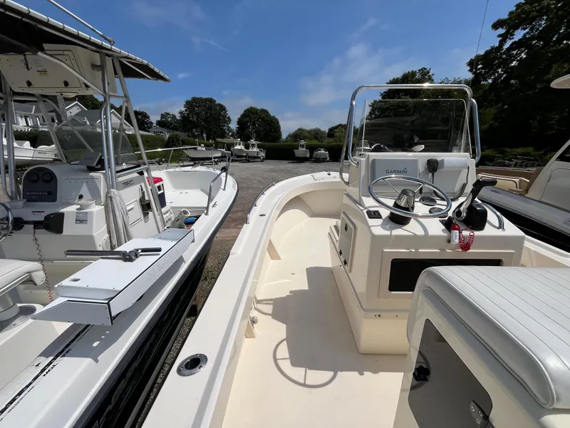 Slide: The Image of 2005 Parker 2100 Special Edition boat with center console, docked alongside similar vessels. - 9
