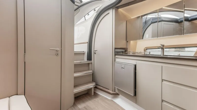 Slide: The Image of Modern interior of 2025 Hanover 415 yacht with sleek kitchen and staircase design. - 15