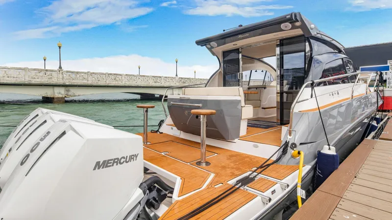 Slide: The Image of Luxury Hanover 415 yacht docked, showcasing sleek design and powerful Mercury engines, 2025 model. - 18