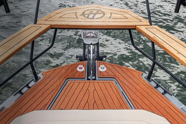Slide: The Image of 2026 Hanover 415 Outboard boat with elegant wooden deck design on water. - 25