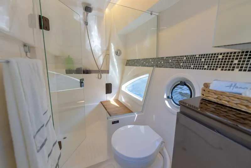 Slide: The Image of Luxurious bathroom in 2025 Hanover 415 yacht with modern fixtures and porthole view. - 33