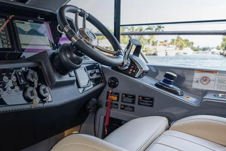 Slide: The Image of Interior view of 2026 Hanover 415 Outboard boat cockpit with steering wheel and controls. - 36