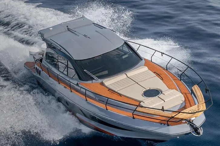 Slide: The Image of 2026 Hanover 415 Outboard cruising on open water, showcasing sleek design and luxury features. - 4