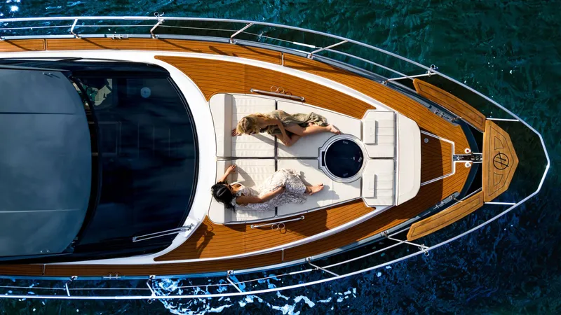 Slide: The Image of Aerial view of Hanover 415 yacht, 2025 model, with two people relaxing on deck. - 5