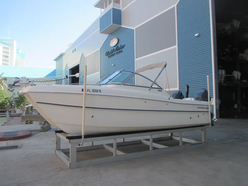 Slide: The Image of 2013 Carolina Cat 230 DC boat on display at a marina. - 0