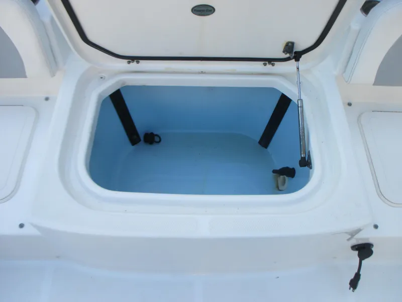 Slide: The Image of Open storage compartment on a 2013 Carolina Cat 230 DC boat. - 10