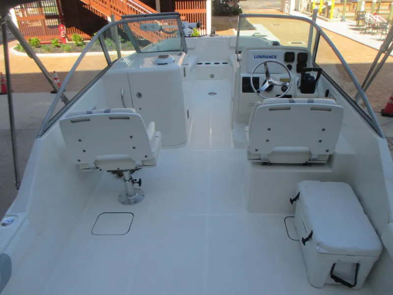 Slide: The Image of 2013 Carolina Cat 230 DC boat interior with seating and steering console. - 12
