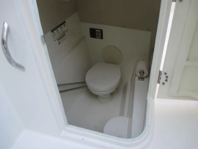 Slide: The Image of 2013 Carolina Cat 230 DC boat interior with compact marine toilet. - 19