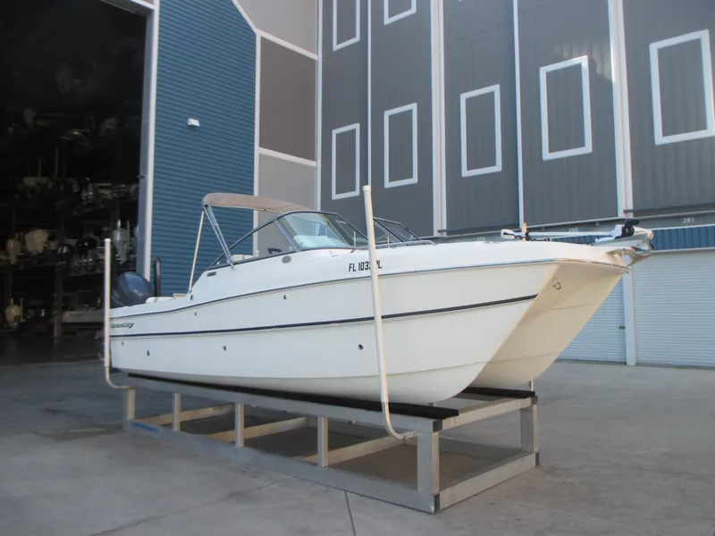 Slide: The Image of 2013 Carolina Cat 230 DC boat on a stand in a storage facility. - 2