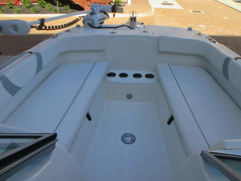 Slide: The Image of 2013 Carolina Cat 230 DC boat interior with seating and cup holders. - 23