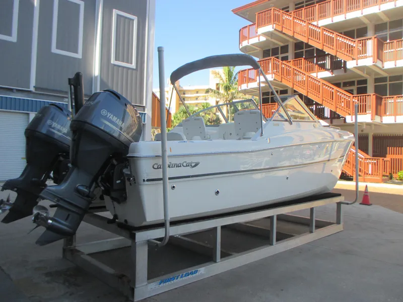 Slide: The Image of 2013 Carolina Cat 230 DC boat with dual Yamaha engines on a trailer. - 4