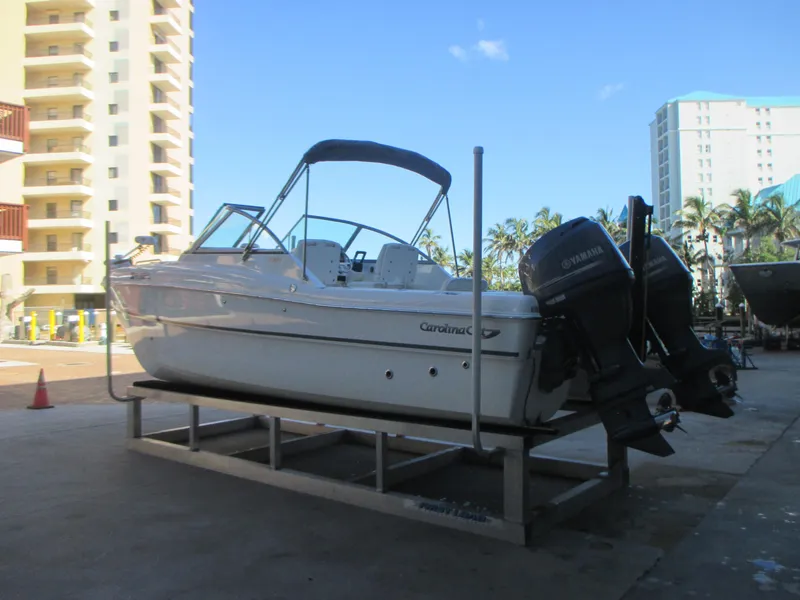 Slide: The Image of 2013 Carolina Cat 230 DC boat on a stand with Yamaha engines, urban background. - 5