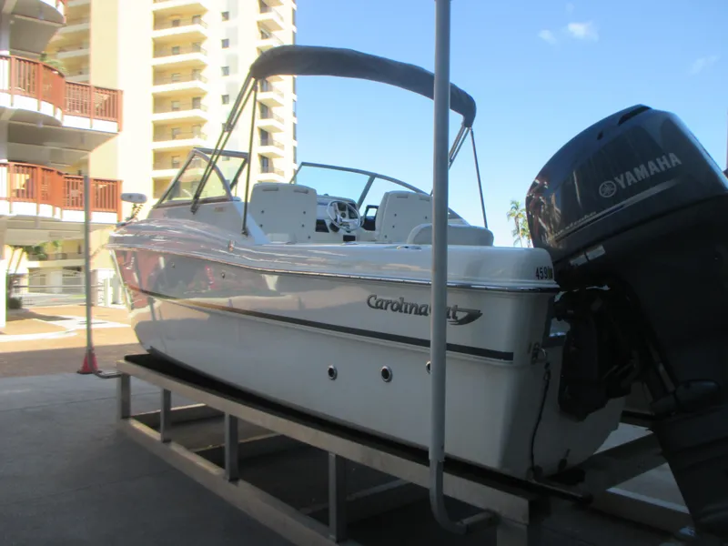 Slide: The Image of 2013 Carolina Cat 230 DC boat with Yamaha engine on a dock. - 6