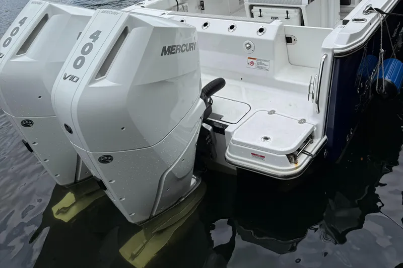 Slide: The Image of 2025 Blackfin 302 CC boat with twin Mercury 400 V10 engines on water. - 7
