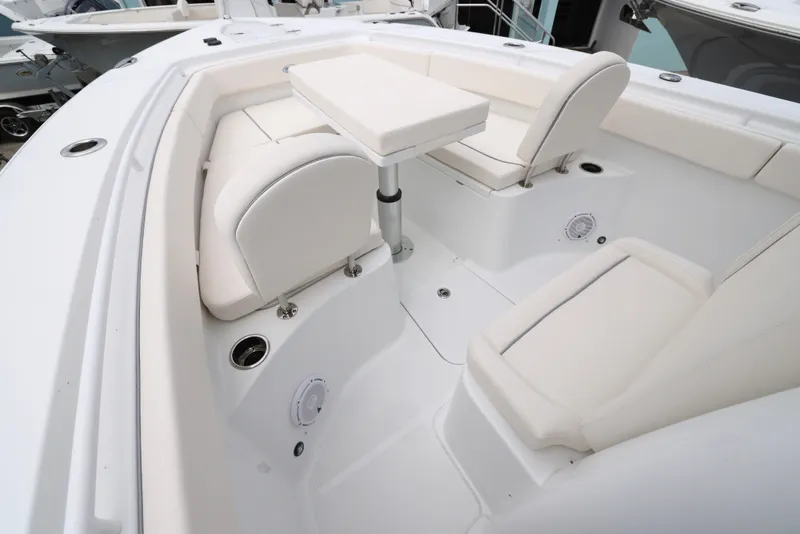 Slide: The Image of 2025 Sea Hunt Gamefish 27 Forward Seating with white cushioned seats and table. - 14