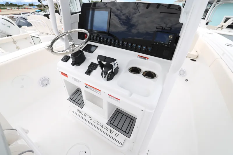 Slide: The Image of 2025 Sea Hunt Gamefish 27 Forward Seating helm with modern controls and electronics. - 16