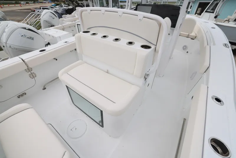 Slide: The Image of 2025 Sea Hunt Gamefish 27 Forward Seating boat interior with white cushioned seats. - 19