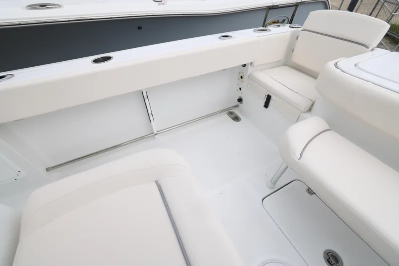 Slide: The Image of 2025 Sea Hunt Gamefish 27 Forward Seating, spacious white interior with cushioned seats. - 29