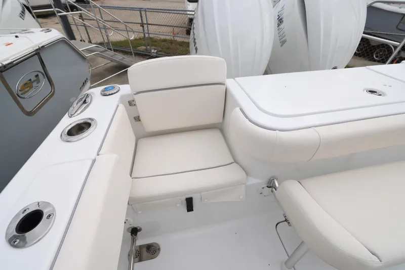 Slide: The Image of 2025 Sea Hunt Gamefish 27 Forward Seating boat interior with white cushioned seats. - 30