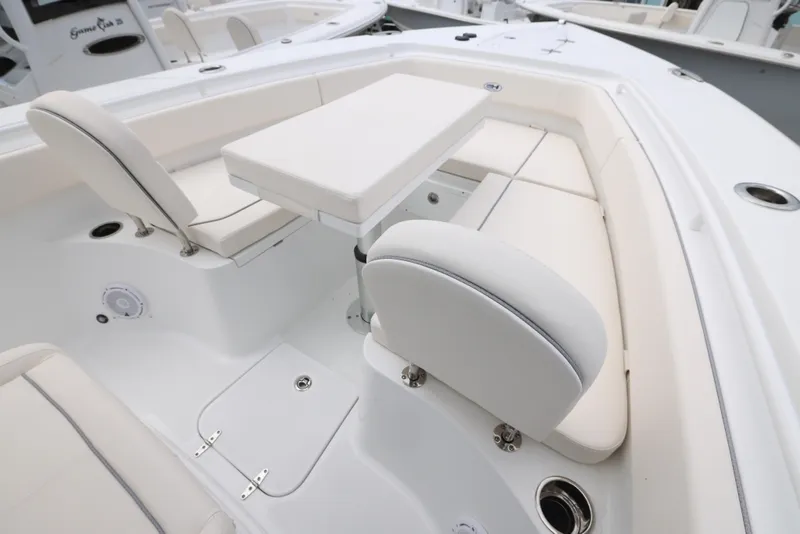 Slide: The Image of 2025 Sea Hunt Gamefish 27 Forward Seating with white cushioned seats and table. - 4
