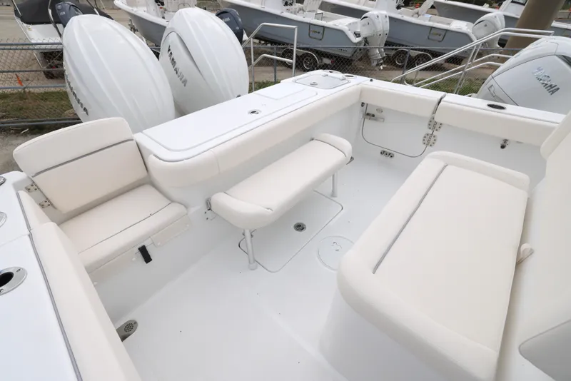 Slide: The Image of 2025 Sea Hunt Gamefish 27 Forward Seating boat interior with white cushioned seats. - 6